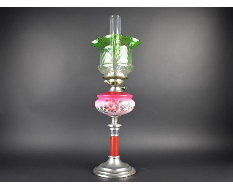 A Late Victorian/Edwardian Oil Lamp with Metal Base, Opaque Pink Glass Reservoir, Green Shade and Plain Chimney, 68cms High 