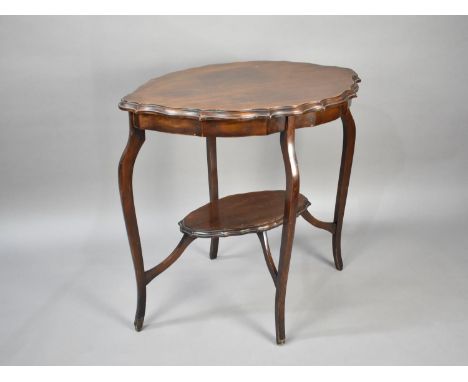 An Edwardian Mahogany Oval Topped Occasional Table with Cabriole Supports and Stretcher Shelf, 71cm wide 