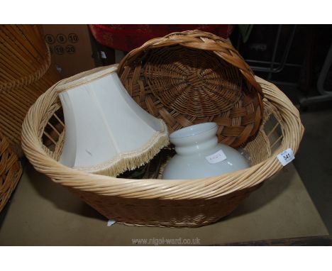 A wicker laundry basket, tins, glass lamp shade etc.