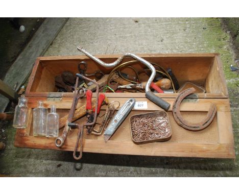 A tool chest with tools, glass bottles etc