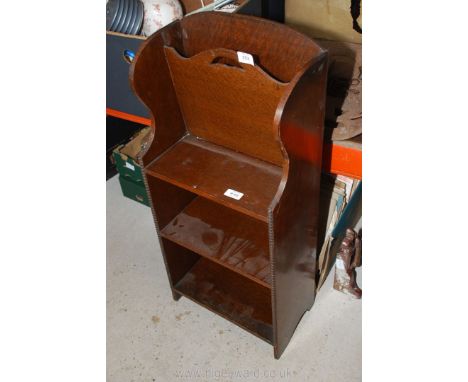 A small three shelf bookcase with magazine rack above.