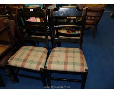 A set of four I. &amp; J.L. Brown ladder back dining chairs with gingham seats.