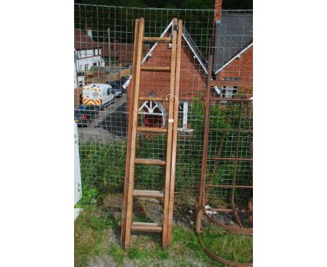 A wooden extending eight rung ladder.