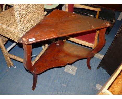 A corner table with lower shelf.