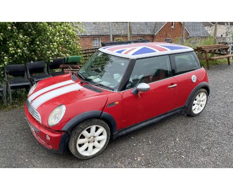 A BMW Mini Cooper, 1st registered on 21st August 2001, 1598 cc, red with white patriotic Union Jack emblazoned roof, petrol, 