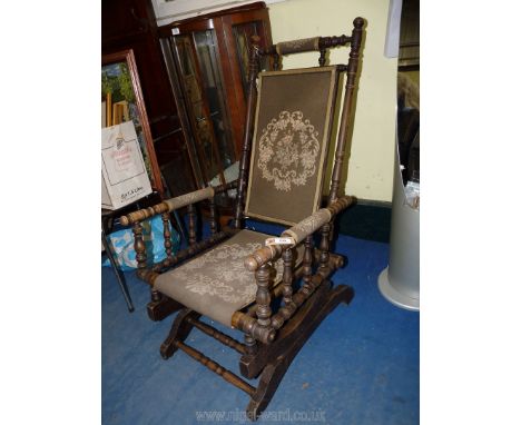 An American rocking chair with tapestry seat.