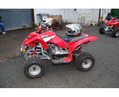 A Dragon 70cc Quad bike, red, with key and helmet. Very little used. Has been standing, but  have started engine Thursday 9th