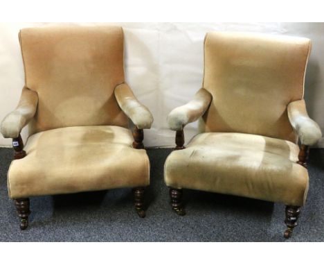 Pair of Victorian mahogany library armchairs with turned, tapered legs and ceramic castors, 87cm.