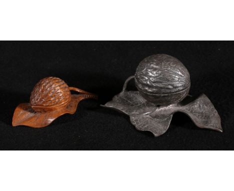 Carved treen fruit wood inkwell in the form of a nut on a leaf, 12cm and another white metal by WWM & Co, 15cm wide (2)