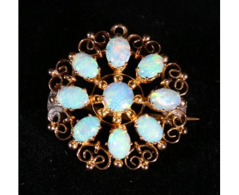 Victorian circular brooch with nine opals on openwork frame. CONDITION REPORT: Outer opals are 0.5cm x 0.3cm.  Central opal 0