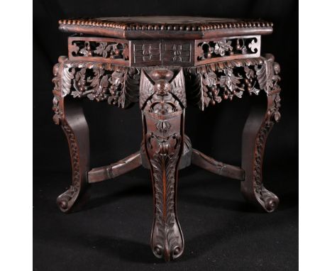 Chinese carved padouk wood jardiniere stand with octagonal top inset with marble on carved scroll legs and pierced and carved