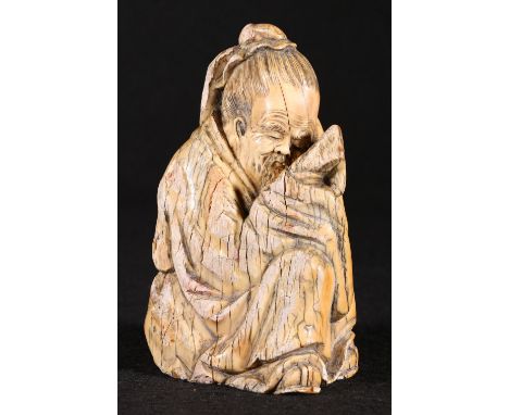 Chinese marine ivory carving of a seated sage holding a scroll, 15cm.