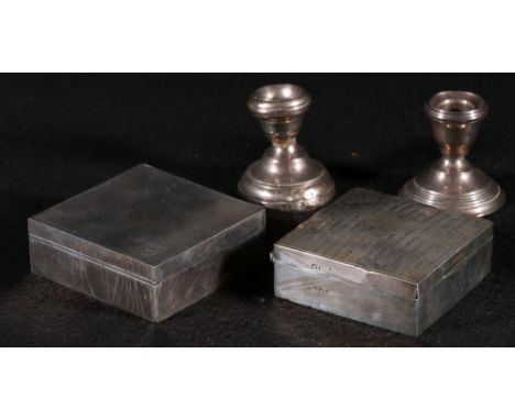 Pair of circular dwarf candlesticks, 6cm, together with two engine turned cigarette boxes. (4)