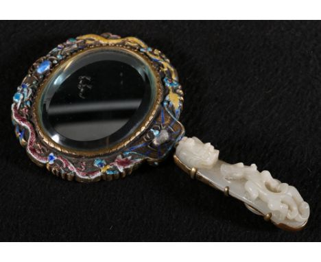 A good 19th century Chinese enamelled and jade gilt metal mirror, the handle made from a jade belt buckle, the bevelled oval 