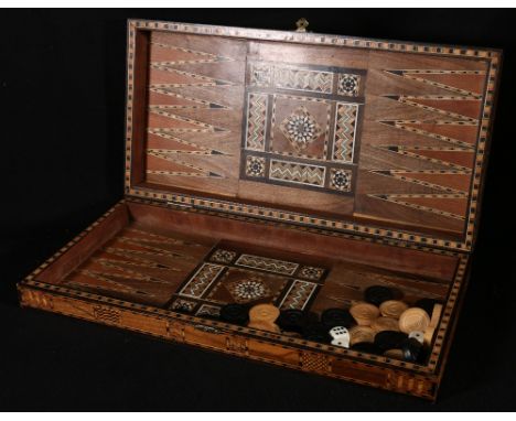 North African parquetry inlaid backgammon and chess board, with central hinges and counters, 50cm long. CONDITION REPORT: Los