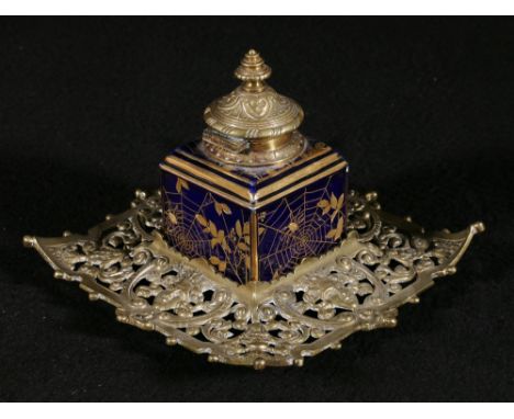 English porcelain inkwell, the blue ground decorated in gilt with spiders webs and branches mounted with brass cover and upon