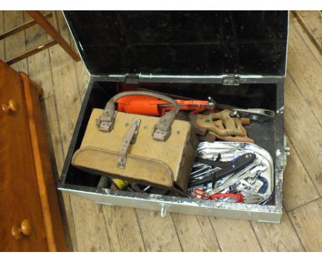 A painted pine tool box containing various saws, spanners and other tools