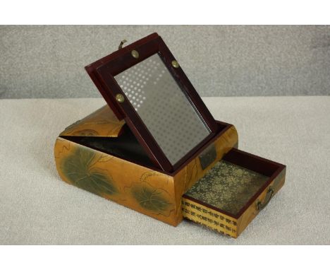 A 20th century Japanese travelling lacquer vanity box with lift-up mirror, decorated with mandarin ducks on a pond and lotus 