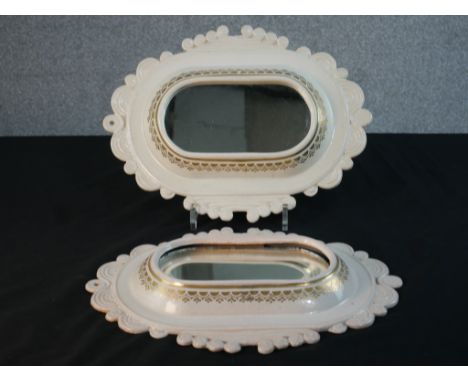 A pair of DRW white ceramic with gilded stencil design wall mirrors. Makers mark to the back. (One mirror panel loose.) H.23 