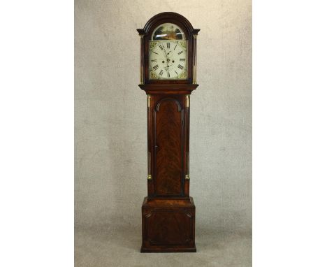 A George III flame mahogany longcase clock, the hood of rounded arch form flanked by columns, the enamelled dial with Roman n