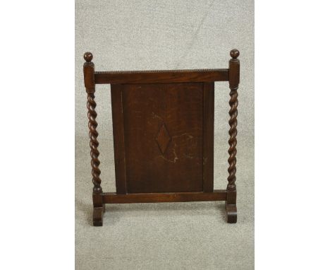An early 20th century fire screen, the central panel with a lozenge design, flanked by barley twist columns. H.66 W.53 D.15cm