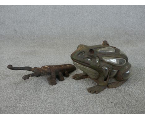 A vintage blown glass and cast iron frog tea light holder along with a long horn beetle boot scraper. H.12 W.24cm (largest) 