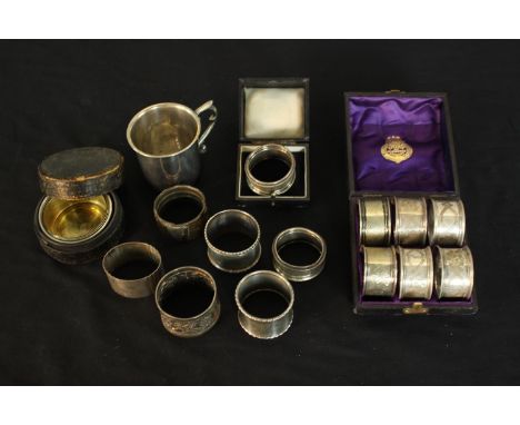 A collection of silver and silver plate, including a cased set of six engraved foliate design napkin rings, a cased silver na