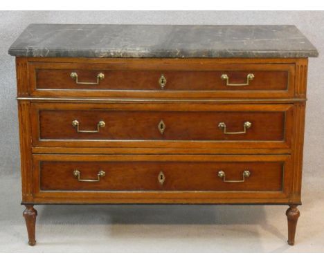 A late 19th century French walnut marble topped commode with three long drawers, brass handles and escutcheons raised on shap
