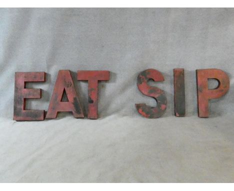 A set of six large red painted metal vintage shop front letters. One word reads' Eat' and one 'Sip'. H.60 W.37cm 