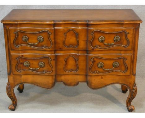 A French provincial chestnut two drawer commode on carved cabriole supports. H.87 W.117 D.48cm 