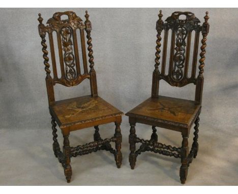 A pair of late 19th century Carolean style hall chairs with carved backs and panel seats on barleytwist stretchered supports.