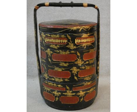 A vintage Chinese four tiered lacquered and gilded marriage basket. Decorated with figures and foliage. H.74cm