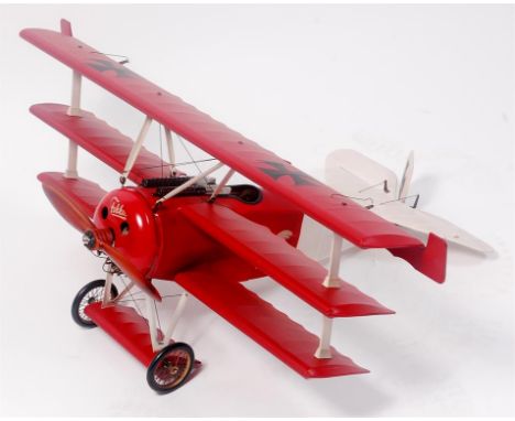 A very well made balsa wood, metal and paper model of a Fokker DR1, finished in red and white, with stained wooden airscrew, 