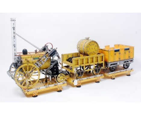 A very well made Meccano 1/8th scale model of the 1829 Stephensons Rocket with Tender and Open Coach, constructed from yellow