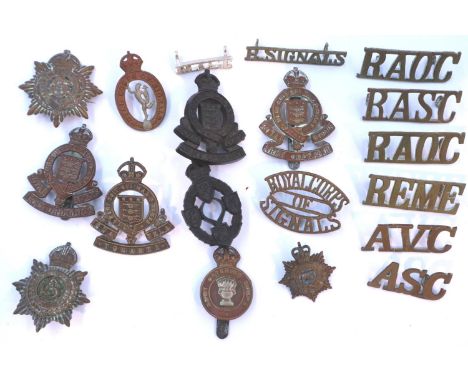A collection of WWI and later cap badges, including Royal Corps of Signals, Ordnance Corps, Catering Corps and Army Service C