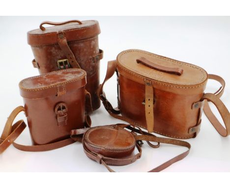 Three military leather binocular cases, including a 1918 dated example, with a marching compass case (4).  P&amp;P Group 2 (£