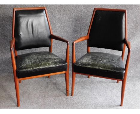 A pair of Danish 1970's vintage teak framed armchairs in deep green leather upholstery. H.97cm 