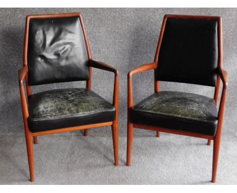 A pair of Danish 1970's vintage teak framed armchairs in deep green leather upholstery, retail label to underside. H.97cm 