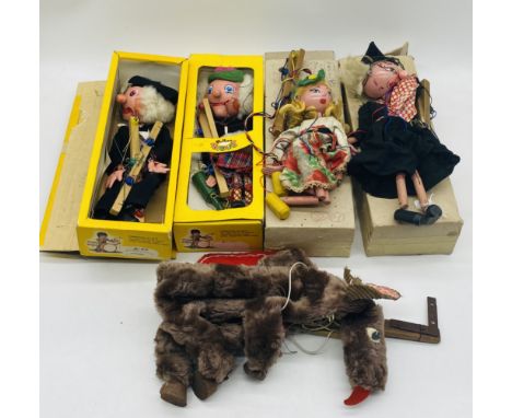 A collection of four boxed vintage Pelham Puppets including Wicked Witch, School Master, McBoozle Marionette and Dutch Girl, 