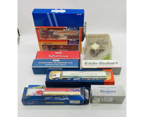 A collection of various die-cast vehicles including Corgi Rugby Cement ERF Powder Tanker (74901), Oxford Quinns Scania EVO 6 