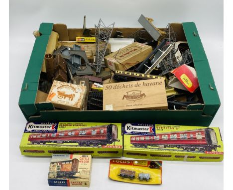 A collection of various model railway accessories including two Kitmaster scale models, signals, pylons, tracks, passenger co