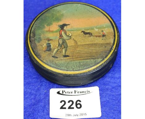 19th Century papier mache circular shaped snuff box, the cover painted with an agricultural farming scene.