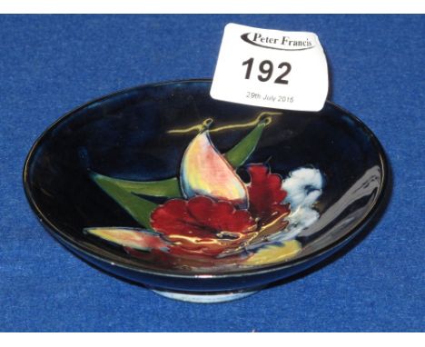 Moorcroft art potter blue ground floral dish with Queen Mary label to base. CONDITION REPORT: 3 minute glaze nicks to the rim