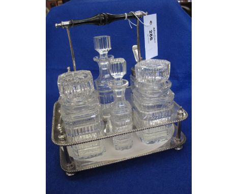 Late Victorian / Edwardian silver plated six bottle cruet stand having beaded edges and turned ebony handle with six cut glas