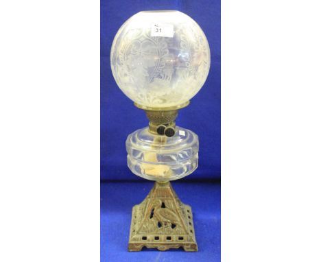 Early 20th Century brass double burner oil lamp with moulded clear reservoir on cast and pierced conical base, with etched gl
