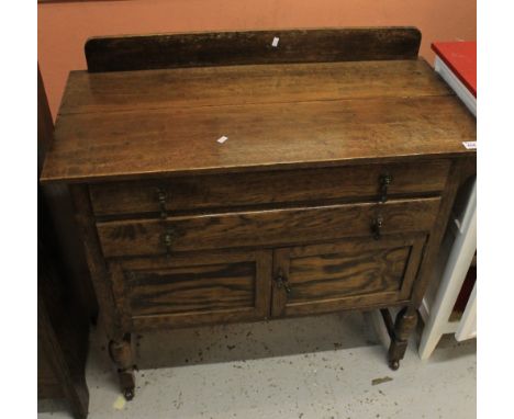 Mid 20th Century oak dressing table chest raised on ceramic casters.