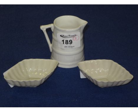 Royal Doulton barrel shaped white ground cream jug together with two Belleek china lozenge shaped fluted pin dishes.  (3) CON