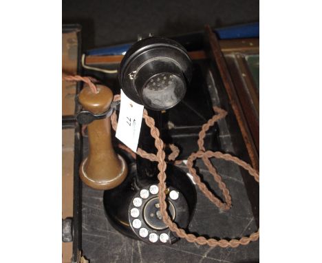 Vintage Bakelite stick telephone with braided cord and wall box.