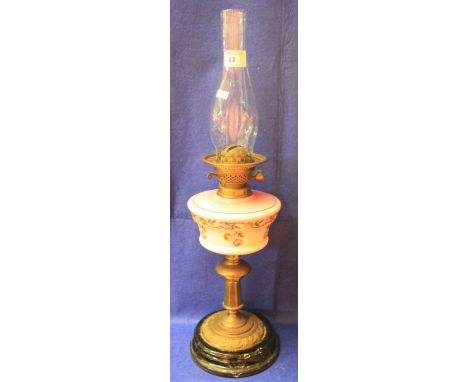Early 20th Century brass double burner oil lamp with floral decorated ceramic reservoir on brass pedestal with ceramic base a