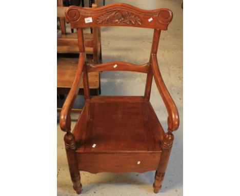 Late 19th/early 20th Century carved, stained commode armchair.